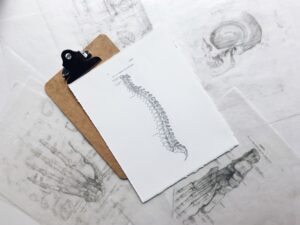 A clipboard with a printed spine with a herniated disc